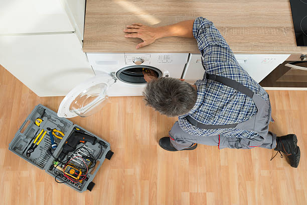 istock Handyman Checking Washing Machine At Home 611185078