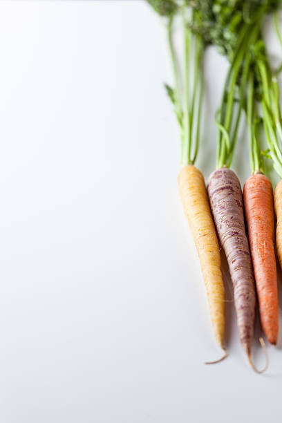 istock Fresh Organic Carrots Raw Colorful Bunch Isolated On White 611185756