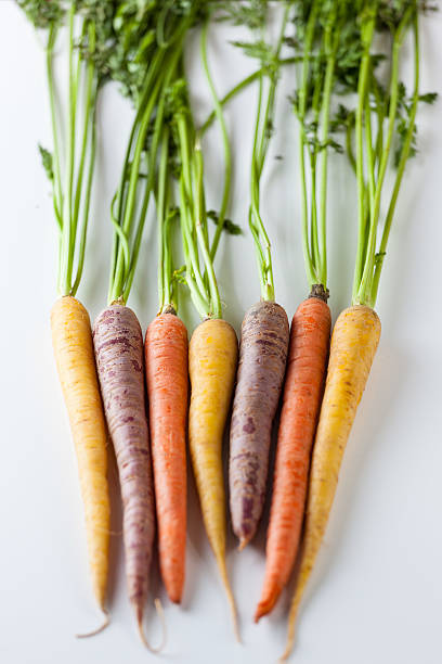 istock Fresh Organic Carrots Raw Colorful Bunch Isolated On White 611185788