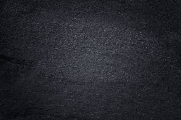 istock Dark grey black slate background or natural stone texture. 611185890