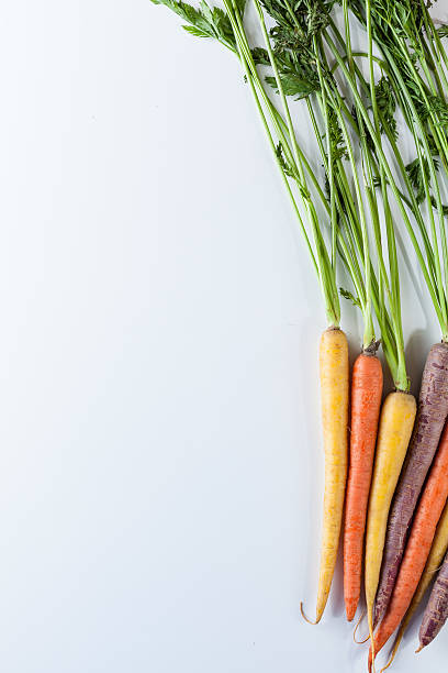istock Fresh Organic Carrots Raw Colorful Bunch Isolated On White 611186062