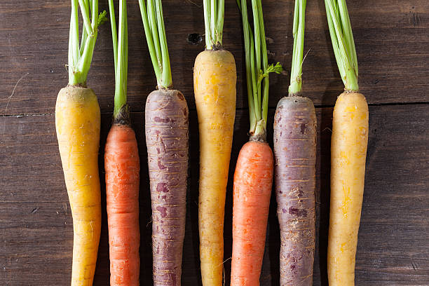 istock Organic Raw Carrots On Vintage Rustic Wood Texture Table Background 611186892