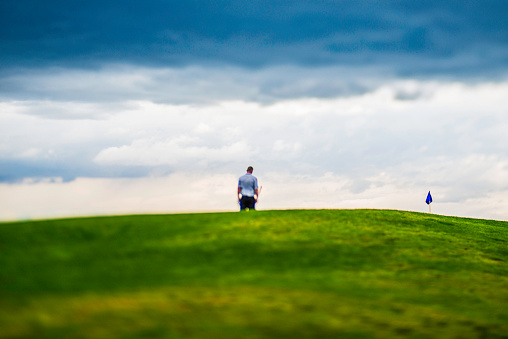 Man looking dejected after missing a putt on golf course