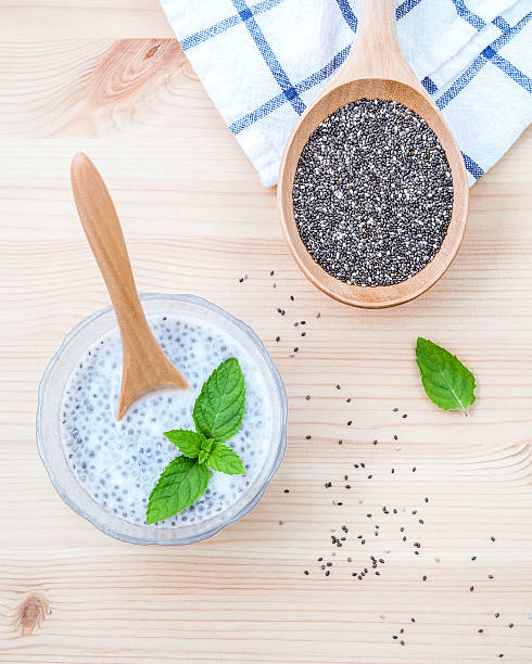 istock Nutritious chia seeds in glass bowl with wooden spoon . 611187378