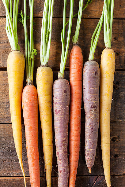 istock Organic Raw Carrots On Vintage Rustic Wood Texture Table Background 611187524