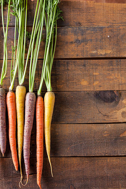 istock Organic Raw Carrots On Vintage Rustic Wood Texture Table Background 611187750