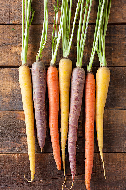 istock Organic Raw Carrots On Vintage Rustic Wood Texture Table Background 611187874