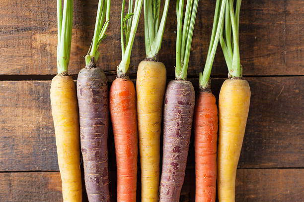 istock Organic Raw Carrots On Vintage Rustic Wood Texture Table Background 611187882