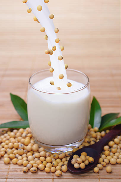 istock Pouring soy milk and beans into clear glass 611189070