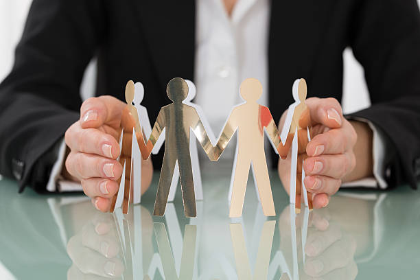 istock Woman Hand Protecting Cut-out Figures 611189750