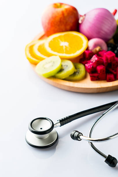 istock Healthy food in heart dish with doctor's stethoscope 611193236