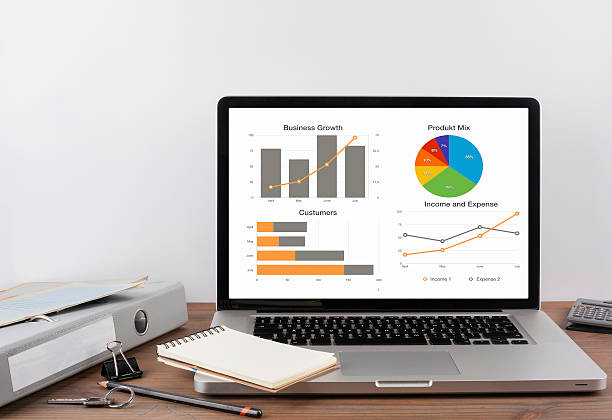 istock Office desk with graphs and charts on a laptop 611196700