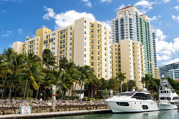 istock hotel buildings with yachts and palm trees 611197726