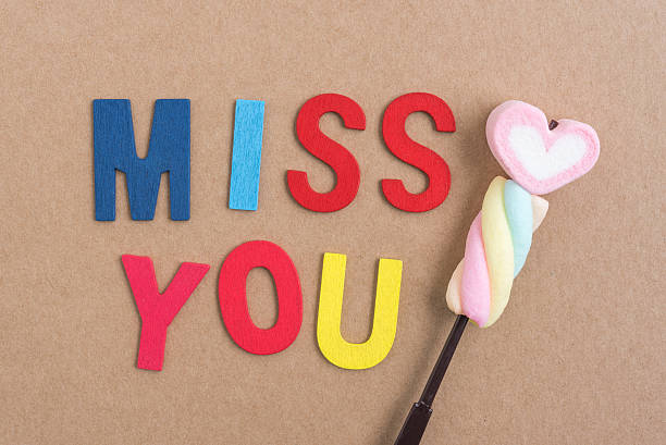 istock Words miss you with heart candy 611197976