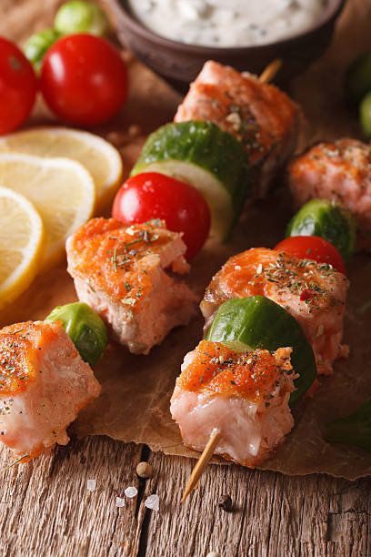 istock Grilled salmon and vegetables on skewers macro. vertical 611199326