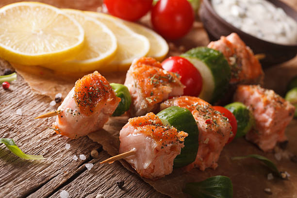 istock Grilled salmon and vegetables on skewers close-up. horizontal 611199546