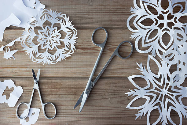 handmade paper snowflakes and scissors