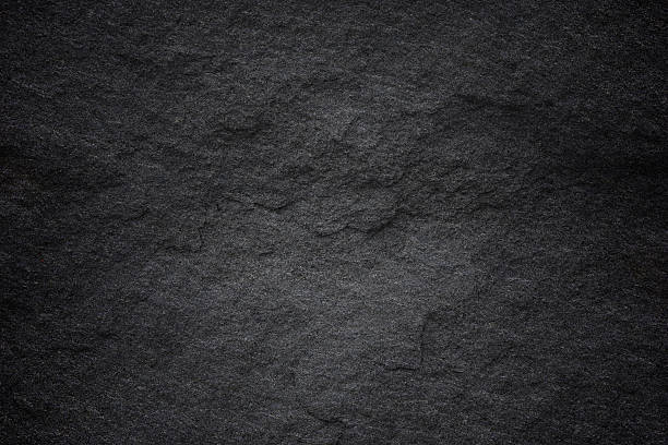 istock Dark grey black slate background or natural stone texture. 611200612