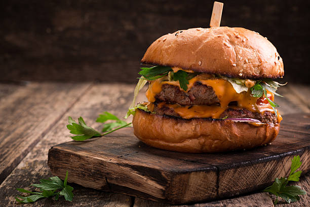 istock Tasty grilled burger with lettuce and mayonnaise , rustic wooden table 611203084