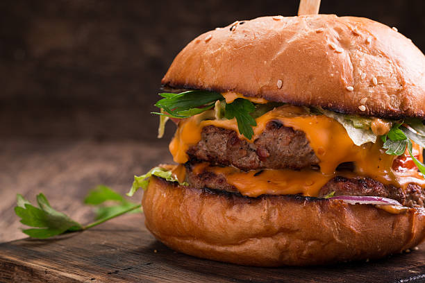 istock Tasty grilled burger with lettuce and mayonnaise , rustic wooden table 611203148
