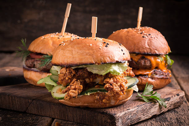 istock Tasty grilled burger with lettuce and mayonnaise , rustic wooden table 611203252
