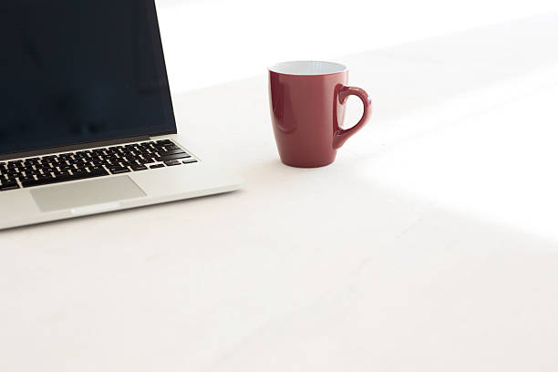 istock Laptop and coffee cup on floor of office 611203894