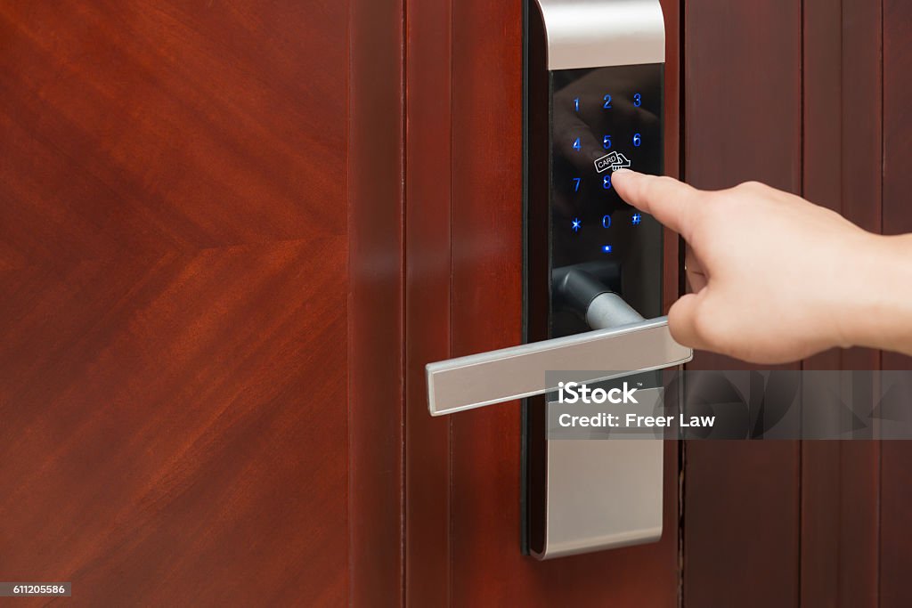 inputing passwords on an electronic door lock Lock Stock Photo