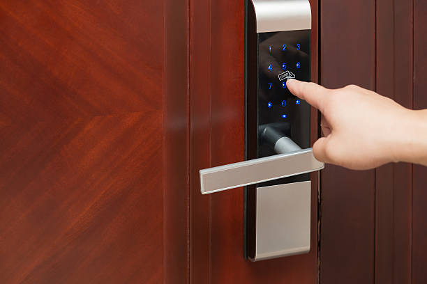 inputing passwords on an electronic door lock stock photo