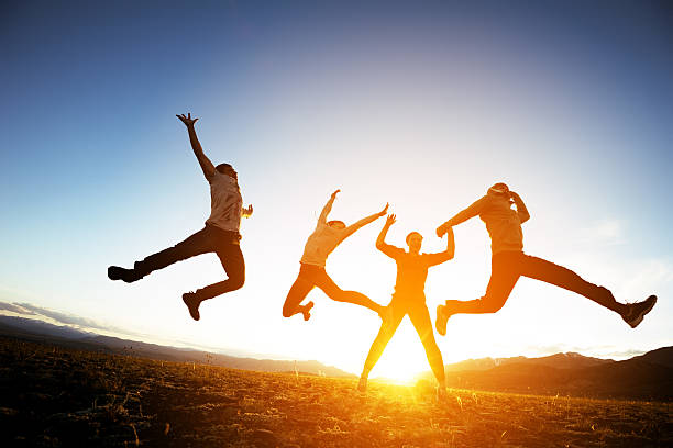 istock Group of friends having fun jumps on sunset and mountains 611207818