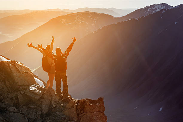 istock Happy couple winner mountain top concept 611207862