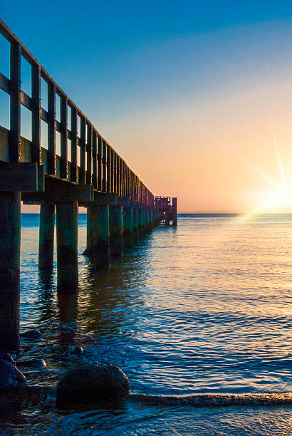 istock Wooden pier with flare 611208912
