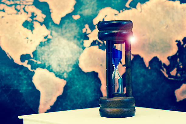 istock Hourglass against grunge world map, with lens flare 611211402
