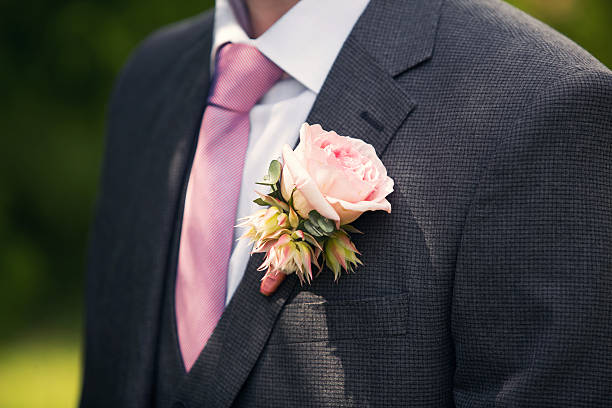 istock groom's buttonhole from a pink rose and a tie 611212084