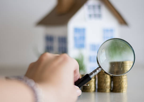 istock Mortgage concept focused on the magnifying glass 611213382