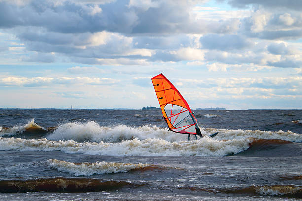 istock Windsurfer on the waves against wind and waves. 611213768