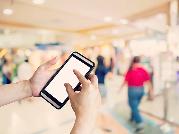 istock Hand woman holding and using phone with blurred background 611214982