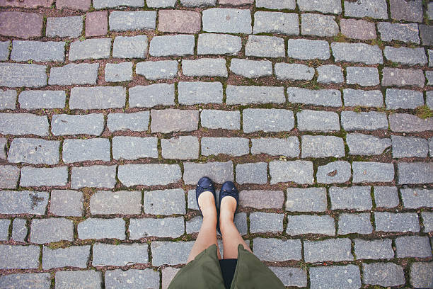 istock female legs on paving stone 611215434
