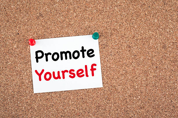 istock Promote yourself. Sticky note on cork board 611289758