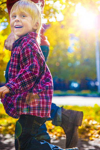 istock Father and Little Son Walking Outdoors in Autumn 611290314