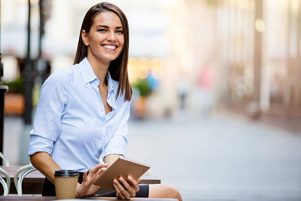 Beautiful young business woman using tablet