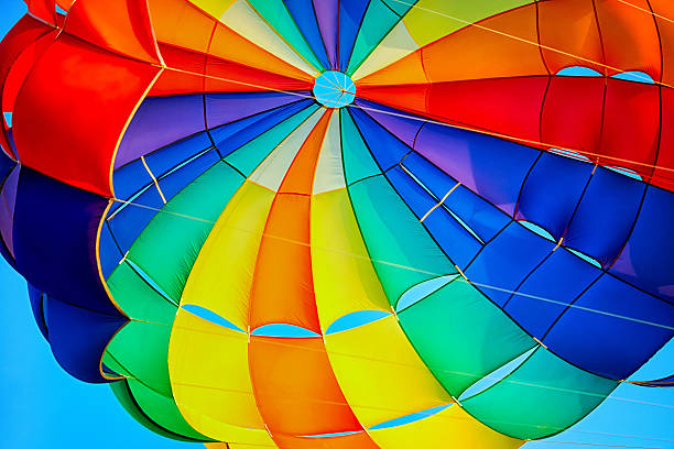 Canopy of a multicolor parachute in air. Canopy of a multicolor parachute in air. parasailing stock pictures, royalty-free photos & images