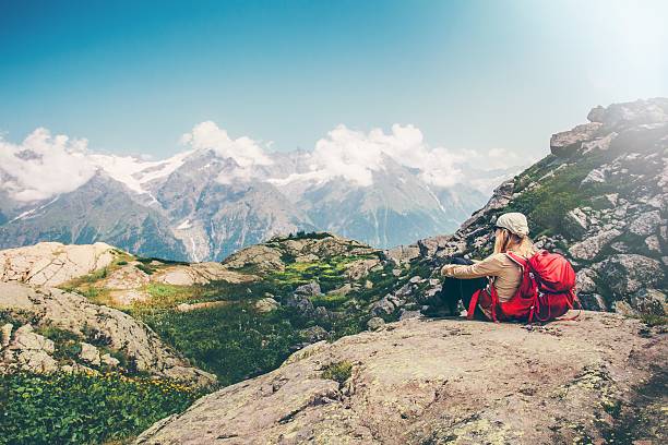 istock Woman Traveler with backpack relaxing with mountains serenity view 611295298