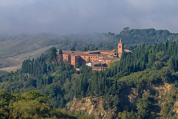 Monte Oliveto Maggiore idyllic monastery surrounded by olive groves in the Crete Senesi