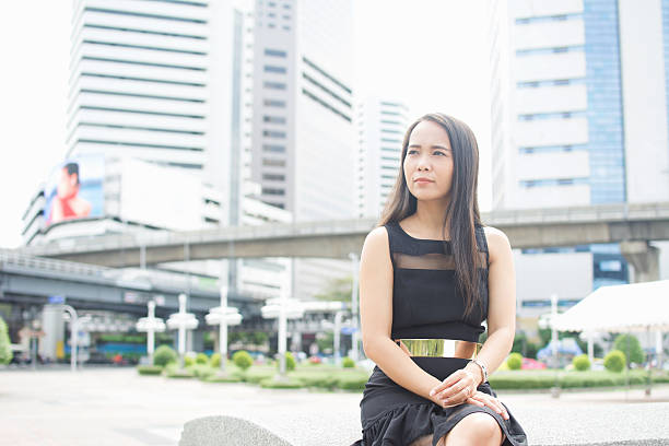 istock Woman sitting in business district. 611298592