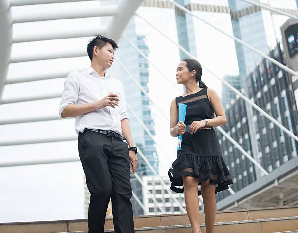 istock Two business colleagues chat together as they walk. 611299934