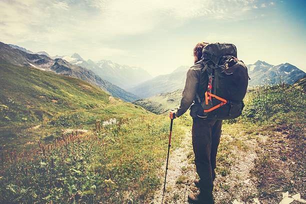 Traveler Man with backpack mountaineering Travel Lifestyle concept rocky mountains on background adventure vacations outdoor