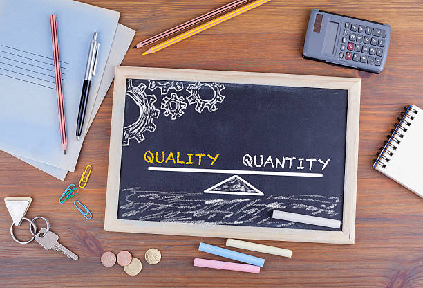 istock Quality Quantity Balance. Chalkboard on wooden office desk 611301314