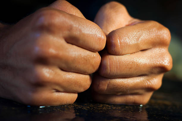 istock closeup of two fists on a rough table. 611301854