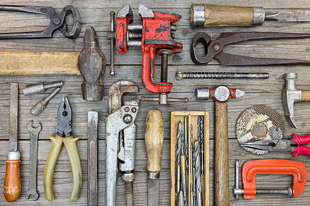 istock old hand tools set on grey wooden boards, flat design 611301948