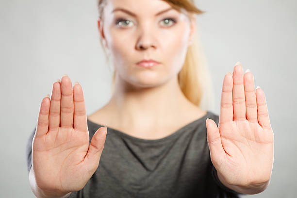 istock Female shows stop sign by her hand. 611303960